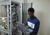 Technician working on server cables with laptop