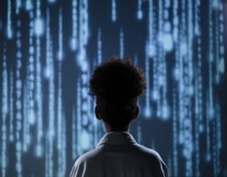 Person facing digital code display on screen